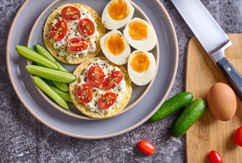 Lunch Box Leftovers - cottage cheese, cherry tomatoes, boiled egg & Qukes with Corn Thins slices